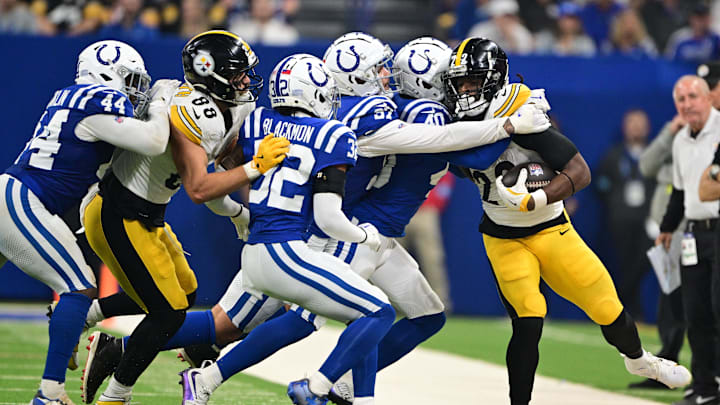 Sep 29, 2024; Indianapolis, Indiana, USA; Pittsburgh Steelers running back Najee Harris (22) is pushed out of bounds by multiple Indianapolis Colts during the second quarter at Lucas Oil Stadium. Mandatory Credit: Marc Lebryk-Imagn Images