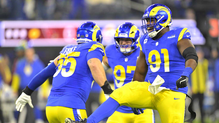 Dec 28, 2024; Inglewood, California, USA;   Los Angeles Rams defensive tackle Braden Fiske (55), linebacker Michael Hoecht (97) and defensive tackle Kobie Turner (91) celerate after a sack of Arizona Cardinals quarterback Kyler Murray (1) in the first half at SoFi Stadium. Mandatory Credit: Jayne Kamin-Oncea-Imagn Images