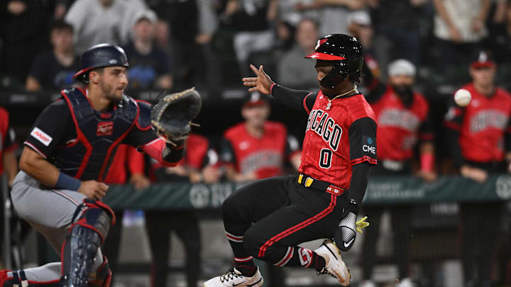 Apr 24, 2026; Chicago, Illinois, USA; Chicago White Sox center fielder Luisangel Acuna (0) slides into home plate to score against Washington Nationals catcher Drew Millas (14) during the seventh inning at Rate Field. Mandatory Credit: Patrick Gorski-Imagn Images