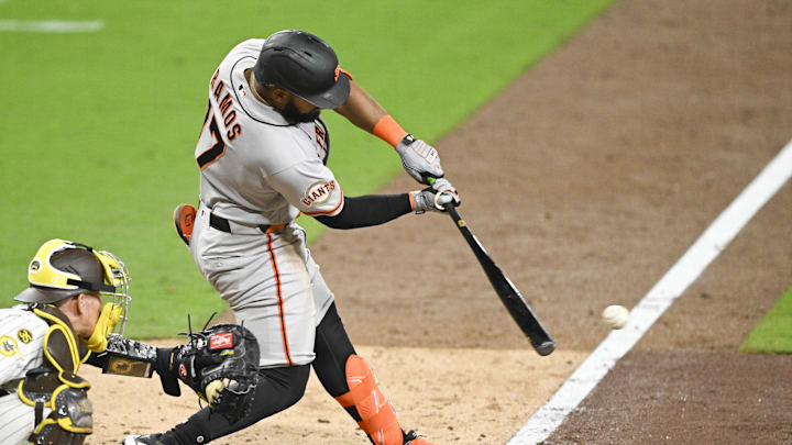 Mar 31, 2026; San Diego, California, USA; San Francisco Giants left fielder Heliot Ramos (17) hits an RBI single during the sixth inning against the San Diego Padres at Petco Park. Mandatory Credit: Denis Poroy-Imagn Images