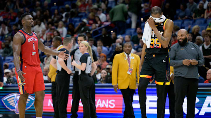 Apr 1, 2024; New Orleans, Louisiana, USA; Phoenix Suns forward Kevin Durant (35) covers his face as he laughs while New Orleans Pelicans forward Zion Williamson (1) tries to argue for a foul during a referee review that was eventually ruled a jump ball during the second half at Smoothie King Center. Mandatory Credit: Matthew Hinton-Imagn Images
