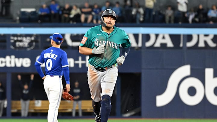 Oct 13, 2025; Toronto, Ontario, CAN; Seattle Mariners first baseman Josh Naylor (12) runs after hitting a two run home run against the Toronto Blue Jays in the seventh inning during game two of the ALCS round for the 2025 MLB playoffs at Rogers Centre. Mandatory Credit: Dan Hamilton-Imagn Images