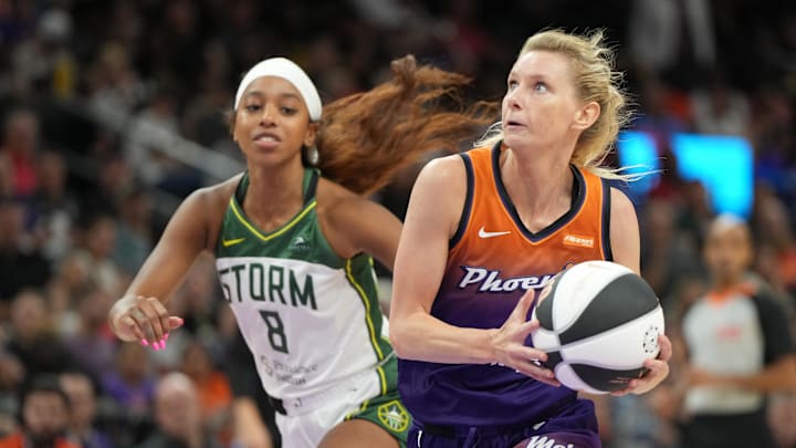 Jun 7, 2025; Phoenix, Arizona, USA; Phoenix Mercury guard Lexi Held (1) drives past Seattle Storm guard Lexie Brown (8) in the second half at Footprint Center. Mandatory Credit: Rick Scuteri-Imagn Images