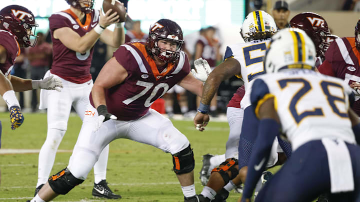 Sep 22, 2022; Blacksburg, Virginia, USA; Virginia Tech Hokies offensive lineman Parker Clements (70) prepares to block West Virginia Mountaineers defensive lineman Dante Stills (55) during the second quarter at Lane Stadium. Mandatory Credit: Reinhold Matay-Imagn Images