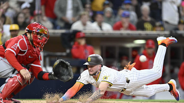 May 12, 2025; San Diego, California, USA; San Diego Padres center fielder Jackson Merrill (3) dives as he scores ahead of the throw to Los Angeles Angels catcher Travis d'Arnaud (25) during the third inning at Petco Park. Mandatory Credit: Denis Poroy-Imagn Images May 12, 2025; San Diego, California, USA; San Diego Padres center fielder Jackson Merrill (3) dives as he scores ahead of the throw to Los Angeles Angels catcher Travis d'Arnaud (25) during the third inning at Petco Park. Mandatory Credit: Denis Poroy-Imagn Images