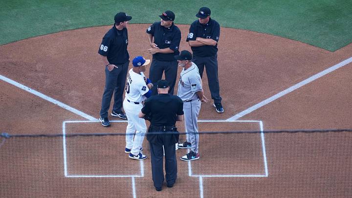 Mar 26, 2026; Los Angeles, California, USA; Los Angeles Dodgers manager Dave Roberts (30) and Arizona Diamondbacks manager Torey Lovullo (17) exchange lineup cards before the game as umpires Andy Fletcher (49), Cory Blaser (89), Jansen Visconti (52) and Alex Tosi (66) look on at Dodger Stadium. Mandatory Credit: Kirby Lee-Imagn Images