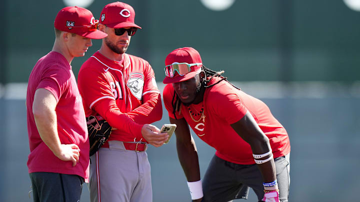 Cincinnati Reds shortstop Matt McLain (9), bench coach Jeff Pickler and shortstop Elly De La Cruz (44) review notes during spring training workouts, Wednesday, Feb. 14, 2024, at the team’s spring training facility in Goodyear, Ariz. Cincinnati Reds shortstop Matt McLain (9), bench coach Jeff Pickler and shortstop Elly De La Cruz (44) review notes during spring training workouts, Wednesday, Feb. 14, 2024, at the team’s spring training facility in Goodyear, Ariz.