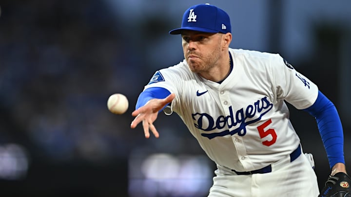 Mar 29, 2025; Los Angeles, California, USA; Los Angeles Dodgers first baseman Freddie Freeman (5) tosses to first for an out during the 3rd inning against the Detroit Tigers at Dodger Stadium. Mandatory Credit: Jonathan Hui-Imagn Images