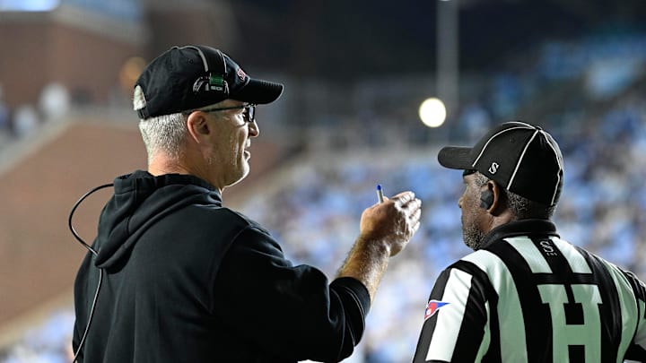 Nov 8, 2025; Chapel Hill, North Carolina, USA; Stanford Cardinal head coach Frank Reich with an official in the third quarter at Kenan Stadium. Mandatory Credit: Bob Donnan-Imagn Images