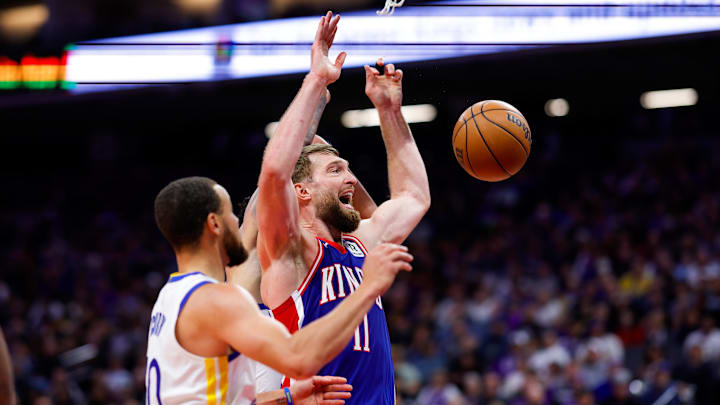 Feb 21, 2025; Sacramento, California, USA; Sacramento Kings forward Domantas Sabonis (11) and Golden State Warriors guard Stephen Curry (30) fight for a rebound during the third quarter at Golden 1 Center. Mandatory Credit: Sergio Estrada-Imagn Images
