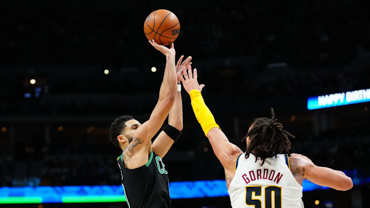 Jan 1, 2023; Denver, Colorado, USA; Boston Celtics forward Jayson Tatum (0) shoots the ball over Denver Nuggets forward Aaron Gordon (50) in the second half at Ball Arena. 