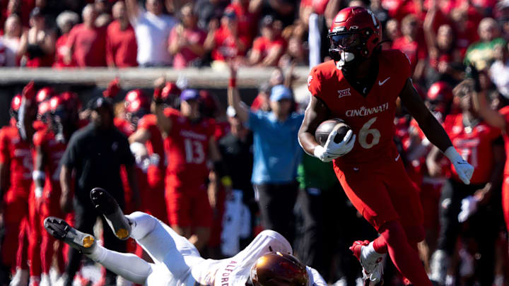 Cincinnati Bearcats running back Evan Pryor (6) scores a touchdown as Arizona State Sun Devils defensive back Xavion Alford (2) dives after him in the second quarter of the College Football game at Nippert Stadium in Cincinnati on Saturday, Oct. 19, 2024. Cincinnati Bearcats running back Evan Pryor (6) scores a touchdown as Arizona State Sun Devils defensive back Xavion Alford (2) dives after him in the second quarter of the College Football game at Nippert Stadium in Cincinnati on Saturday, Oct. 19, 2024.