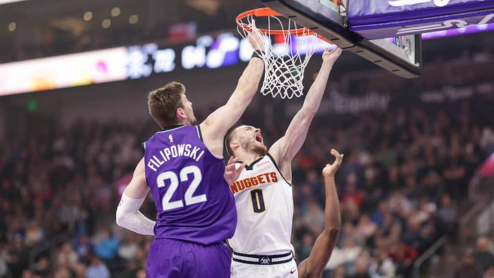 Apr 1, 2026; Salt Lake City, Utah, USA;  Denver Nuggets guard Christian Braun (0) gets past Utah Jazz center Kyle Filipowski (22) and shoots the ball during the second half at Delta Center. Mandatory Credit: Chris Nicoll-Imagn Images