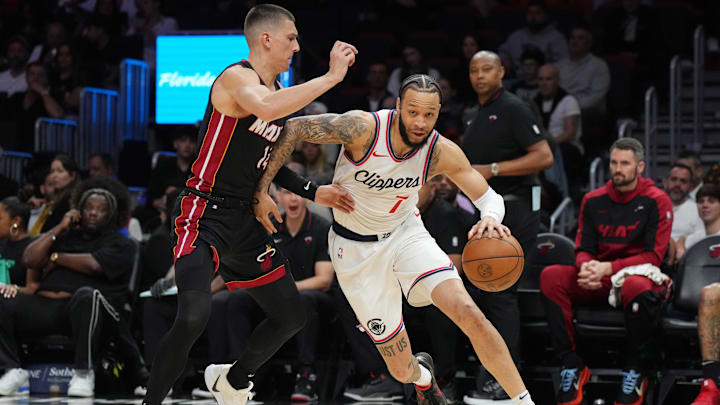 Mar 12, 2025; Miami, Florida, USA; LA Clippers guard Amir Coffey (7) drives past Miami Heat guard Tyler Herro (14) during the first half at Kaseya Center. Mandatory Credit: Jim Rassol-Imagn Images Mar 12, 2025; Miami, Florida, USA; LA Clippers guard Amir Coffey (7) drives past Miami Heat guard Tyler Herro (14) during the first half at Kaseya Center. Mandatory Credit: Jim Rassol-Imagn Images