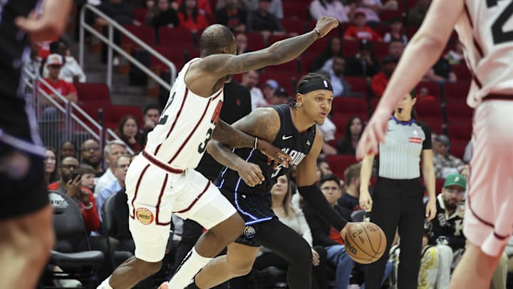 Mar 10, 2025; Houston, Texas, USA; Orlando Magic forward Paolo Banchero (5) dribbles the ball as Houston Rockets forward Jeff Green (32) defends during the fourth quarter at Toyota Center. Mandatory Credit: Troy Taormina-Imagn Images