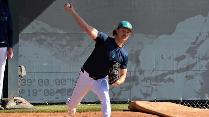 Bryce Miller (50) throws during a Spring Training workout at Peoria Sports Complex.