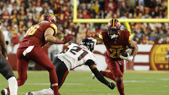 Dec 29, 2024; Landover, Maryland, USA; Washington Commanders safety Quan Martin (20) carries the ball as Atlanta Falcons cornerback Mike Hughes (21) defends during the first half at Northwest Stadium. Mandatory Credit: Amber Searls-Imagn Images Dec 29, 2024; Landover, Maryland, USA; Washington Commanders safety Quan Martin (20) carries the ball as Atlanta Falcons cornerback Mike Hughes (21) defends during the first half at Northwest Stadium. Mandatory Credit: Amber Searls-Imagn Images