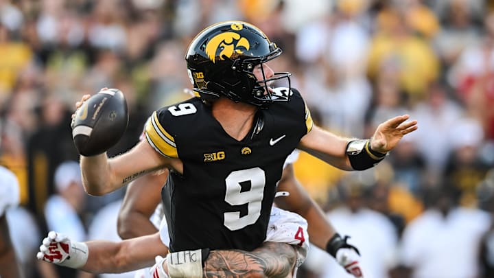 Sep 27, 2025; Iowa City, Iowa, USA; Indiana Hoosiers linebacker Aiden Fisher (4) hits Iowa Hawkeyes quarterback Hank Brown (9) during the fourth quarter at Kinnick Stadium. Mandatory Credit: Jeffrey Becker-Imagn Images