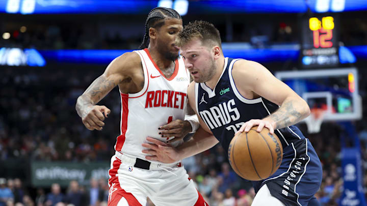 Oct 31, 2024; Dallas, Texas, USA; Dallas Mavericks guard Luka Doncic (77) drives to the basket as Houston Rockets guard Jalen Green (4) defends during the second half  at American Airlines Center. Mandatory Credit: Kevin Jairaj-Imagn Images