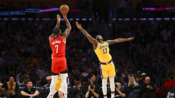 Apr 11, 2025; Los Angeles, California, USA; Los Angeles Lakers forward Dorian Finney-Smith (17) attempts to block against Houston Rockets forward Cam Whitmore (7) during the first half at Crypto.com Arena. Mandatory Credit: Jonathan Hui-Imagn Images