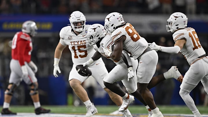 Jan 10, 2025; Arlington, Texas, USA; Texas Longhorns linebacker David Gbenda (33) celebrates with defensive lineman Bill Norton (15) and linebacker Barryn Sorrell (88) after an interception during the third quarter of the College Football Playoff semifinal against the Ohio State Buckeyes in the Cotton Bowl at AT&T Stadium. Mandatory Credit: Jerome Miron-Imagn Images Jan 10, 2025; Arlington, Texas, USA; Texas Longhorns linebacker David Gbenda (33) celebrates with defensive lineman Bill Norton (15) and linebacker Barryn Sorrell (88) after an interception during the third quarter of the College Football Playoff semifinal against the Ohio State Buckeyes in the Cotton Bowl at AT&T Stadium. Mandatory Credit: Jerome Miron-Imagn Images
