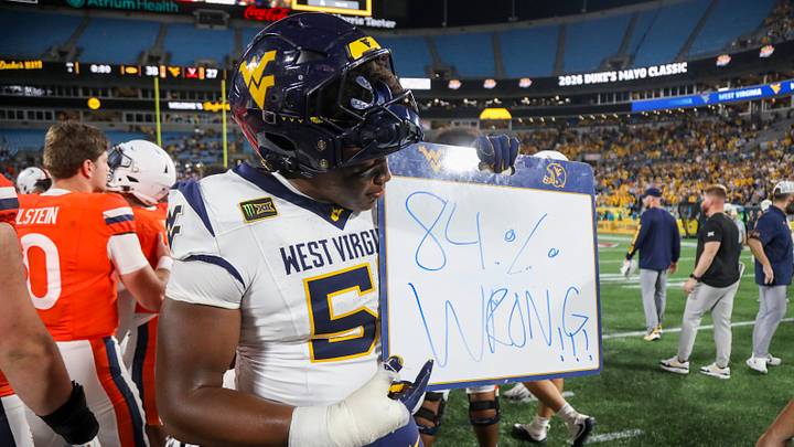 Sep 19, 2026; Charlotte, North Carolina, USA; West Virginia Mountaineers defensive lineman Taylor Brown (51) holds a sign as he celebrates after defeating the Virginia Cavaliers at Bank of America Stadium. Mandatory Credit: Ben Queen-Imagn Images Sep 19, 2026; Charlotte, North Carolina, USA; West Virginia Mountaineers defensive lineman Taylor Brown (51) holds a sign as he celebrates after defeating the Virginia Cavaliers at Bank of America Stadium. Mandatory Credit: Ben Queen-Imagn Images