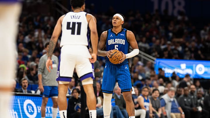 Mar 29, 2025; Orlando, Florida, USA; Orlando Magic forward Paolo Banchero (5) holds the ball against Sacramento Kings forward Trey Lyles (41) in the fourth quarter at Kia Center. Mandatory Credit: Jeremy Reper-Imagn Images Mar 29, 2025; Orlando, Florida, USA; Orlando Magic forward Paolo Banchero (5) holds the ball against Sacramento Kings forward Trey Lyles (41) in the fourth quarter at Kia Center. Mandatory Credit: Jeremy Reper-Imagn Images