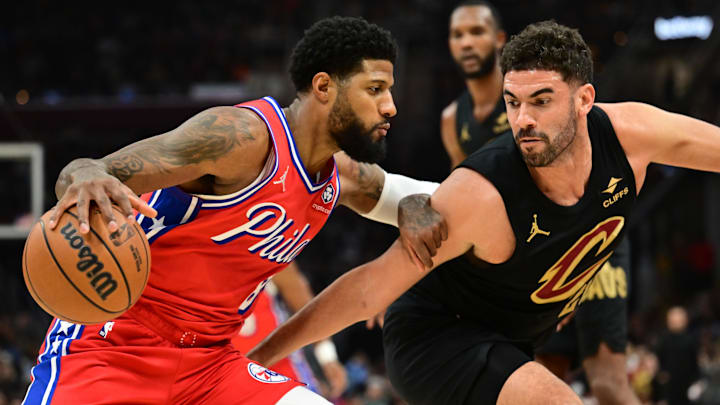Dec 21, 2024; Cleveland, Ohio, USA; Philadelphia 76ers forward Paul George (8) drives to the basket against Cleveland Cavaliers forward Georges Niang (20) during the first half at Rocket Mortgage FieldHouse. Mandatory Credit: Ken Blaze-Imagn Images