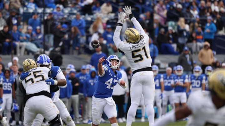 Nov 29, 2025; Provo, Utah, USA; BYU Cougars quarterback Bear Bachmeier (47) throws over the reach of UCF Knights defensive end Malachi Lawrence (51) during the second half at LaVell Edwards Stadium. Mandatory Credit: Rob Gray-Imagn Images Nov 29, 2025; Provo, Utah, USA; BYU Cougars quarterback Bear Bachmeier (47) throws over the reach of UCF Knights defensive end Malachi Lawrence (51) during the second half at LaVell Edwards Stadium. Mandatory Credit: Rob Gray-Imagn Images
