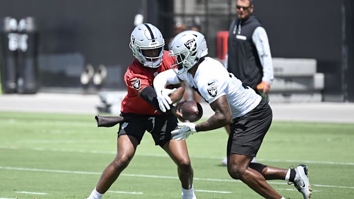 Jun 10, 2025; Henderson, NV, USA; Las Vegas Raiders quarterback Geno Smith (7) hands the ball to running back Raheem Mostert (31) during Las Vegas Raiders Minicamp at Intermountain Health Performance Center. Mandatory Credit: Candice Ward-Imagn Images