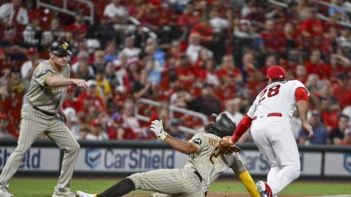 Aug 28, 2023; St. Louis, Missouri, USA;  St. Louis Cardinals third baseman Nolan Arenado (28) tags out San Diego Padres shortstop Xander Bogaerts (2) during the sixth inning at Busch Stadium. Mandatory Credit: Jeff Curry-Imagn Images