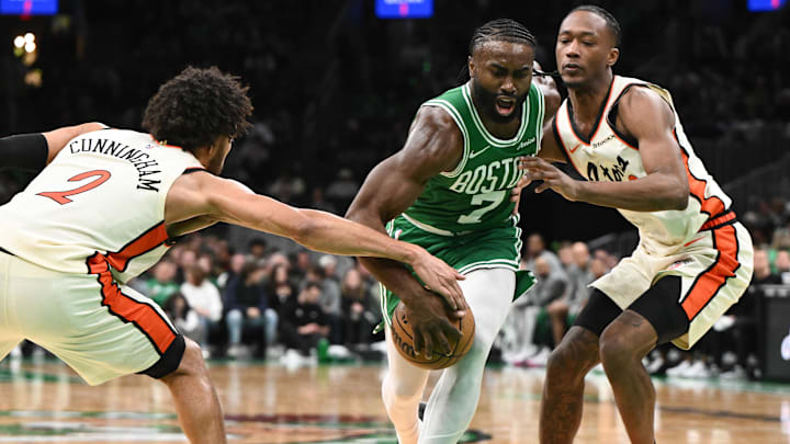 Dec 4, 2024; Boston, Massachusetts, USA; Boston Celtics guard Jaylen Brown (7) drives to the basket against Detroit Pistons guard Cade Cunningham (2) and forward Ronald Holland II (00) during the third quarter at the TD Garden. Mandatory Credit: Brian Fluharty-Imagn Images