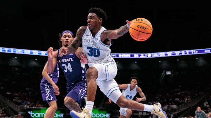Mar 10, 2026; Kansas City, MO, USA; BYU Cougars forward Kennard Davis Jr. (30) drives to the basket around Kansas State Wildcats guard Nate Johnson (34) during the first half at T-Mobile Center. Mandatory Credit: William Purnell-Imagn Images Mar 10, 2026; Kansas City, MO, USA; BYU Cougars forward Kennard Davis Jr. (30) drives to the basket around Kansas State Wildcats guard Nate Johnson (34) during the first half at T-Mobile Center. Mandatory Credit: William Purnell-Imagn Images