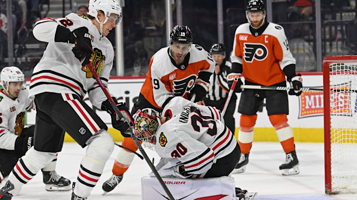 Mar 26, 2026; Philadelphia, Pennsylvania, USA; Chicago Blackhawks defenseman Alex Vlasic (72) picks up the loose puck after goaltender Spencer Knight (30) made a save against the Philadelphia Flyers during the third period at Xfinity Mobile Arena. Mandatory Credit: Eric Hartline-Imagn Images