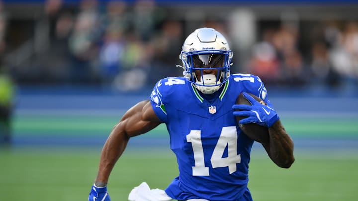 Oct 10, 2024; Seattle, Washington, USA; Seattle Seahawks wide receiver DK Metcalf (14) carries the ball after a catch during the first half against the San Francisco 49ers at Lumen Field. Mandatory Credit: Steven Bisig-Imagn Images