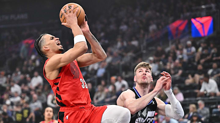 Apr 9, 2025; Salt Lake City, UT; Toumani Camara shoots over Kyle Filipowski in the second half of a game against the Jazz at Delta Center