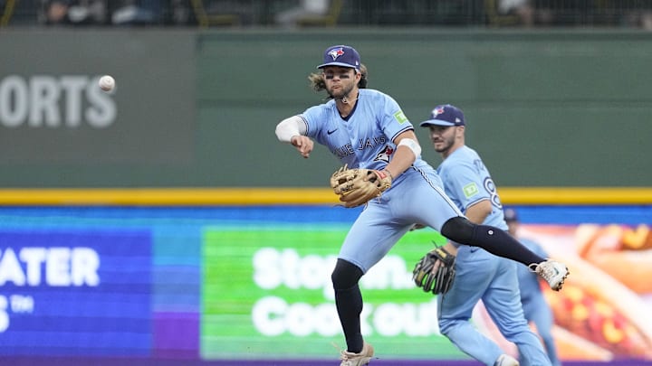 Jun 10, 2024; Milwaukee, Wisconsin, USA;  Toronto Blue Jays shortstop Bo Bichette (11) throws to first base during the second inning against the Milwaukee Brewers at American Family Field. Mandatory Credit: Jeff Hanisch-USA TODAY Sports