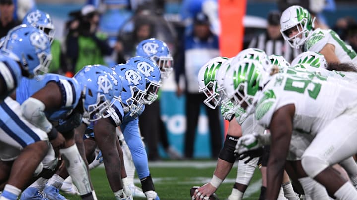 Dec 28, 2022; San Diego, CA, USA; The North Carolina Tar Heels defensive line and Oregon Ducks offensive line before the snap during the second half of the 2022 Holiday Bowl at Petco Park. Mandatory Credit: Orlando Ramirez-Imagn Images