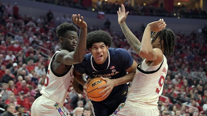Jan 18, 2025; Louisville, Kentucky, USA; Virginia Cavaliers forward Jacob Cofie (5) drives to the basket against Louisville Cardinals forward Aboubacar Traore (25) and forward Khani Rooths (9) during the first half at KFC Yum! Center. Mandatory Credit: Jamie Rhodes-Imagn Images Jan 18, 2025; Louisville, Kentucky, USA; Virginia Cavaliers forward Jacob Cofie (5) drives to the basket against Louisville Cardinals forward Aboubacar Traore (25) and forward Khani Rooths (9) during the first half at KFC Yum! Center. Mandatory Credit: Jamie Rhodes-Imagn Images
