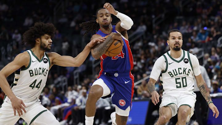 Dec 6, 2025; Detroit, Michigan, USA;  Detroit Pistons guard Daniss Jenkins (24) defended by in the second half against the Milwaukee Bucks at Little Caesars Arena. Mandatory Credit: Rick Osentoski-Imagn Images