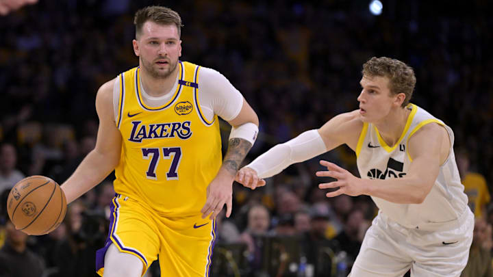 Feb 10, 2025; Los Angeles, California, USA; Los Angeles Lakers guard Luka Doncic (77) is defended by Utah Jazz forward Lauri Markkanen (23) in the first quarter at Crypto.com Arena. Mandatory Credit: Jayne Kamin-Oncea-Imagn Images