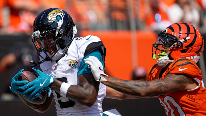 Jacksonville Jaguars wide receiver Dyami Brown (5) catches a pass ahead of Cincinnati Bengals cornerback DJ Turner II (20) for a touchdown in the first quarter of the NFL Week 2 game between the Cincinnati Bengals and the Jacksonville Jaguars at Paycor Stadium in downtown Cincinnati on Sunday, Sept. 14, 2025. The Jaguars led 17-10 at halftime.