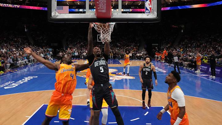 Apr 10, 2026; Charlotte, North Carolina, USA; Detroit Pistons forward Ronald Holland II (5) makes a slam dunk against Charlotte Hornets guard Sion James (4) during the second half at Spectrum Center. Mandatory Credit: Jim Dedmon-Imagn Images
