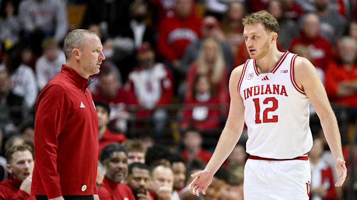 Nov 29, 2025; Bloomington, Indiana, USA; Indiana Hoosiers head coach Darian Devries and Indiana Hoosiers forward Tucker Devries (12) talk during the first half against the Bethune-Cookman Wildcats at Simon Skjodt Assembly Hall. Mandatory Credit: Robert Goddin-Imagn Images Nov 29, 2025; Bloomington, Indiana, USA; Indiana Hoosiers head coach Darian Devries and Indiana Hoosiers forward Tucker Devries (12) talk during the first half against the Bethune-Cookman Wildcats at Simon Skjodt Assembly Hall. Mandatory Credit: Robert Goddin-Imagn Images