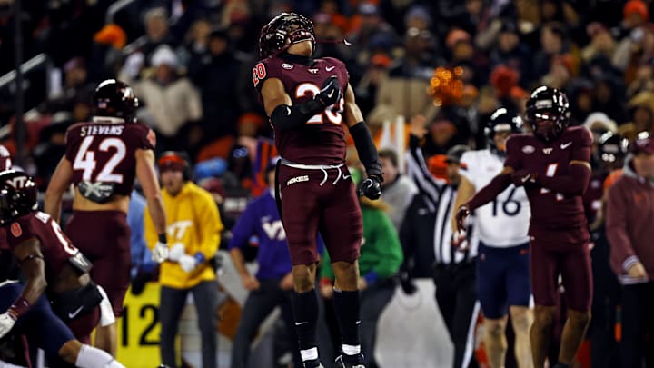 Nov 30, 2024; Blacksburg, Virginia, USA; Virginia Tech Hokies linebacker Caleb Woodson (20) celebrates after a play during the second quarter against the Virginia Cavaliers at Lane Stadium. Mandatory Credit: Peter Casey-Imagn Images
