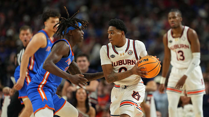 Apr 5, 2025; San Antonio, TX, USA; Auburn Tigers guard Tahaad Pettiford (0) controls the ball against Florida Gatorsguard Denzel Aberdeen (11) during the second half in the semifinals of the men's Final Four of the 2025 NCAA Tournament at the Alamodome. Mandatory Credit: Bob Donnan-Imagn Images