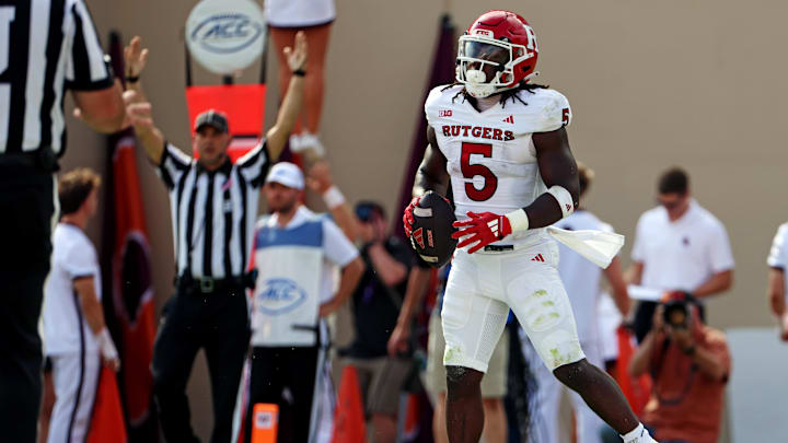 Sep 21, 2024; Blacksburg, Virginia, USA; Rutgers Scarlet Knights running back Kyle Monangai (5) celebrates after scoring a touchdown during the first quarter against the Virginia Tech Hokies at Lane Stadium. Mandatory Credit: Peter Casey-Imagn Images Sep 21, 2024; Blacksburg, Virginia, USA; Rutgers Scarlet Knights running back Kyle Monangai (5) celebrates after scoring a touchdown during the first quarter against the Virginia Tech Hokies at Lane Stadium. Mandatory Credit: Peter Casey-Imagn Images