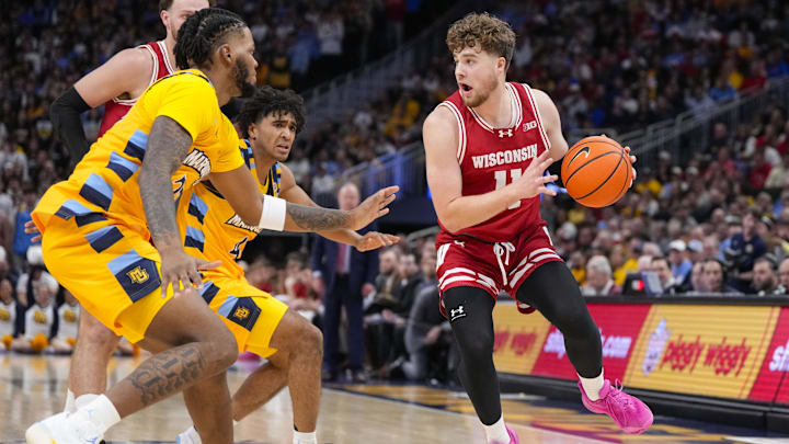 Dec 7, 2024; Milwaukee, Wisconsin, USA;  Wisconsin Badgers guard Max Klesmit (11) looks to pass the ball during the first half against the Marquette Golden Eagles at Fiserv Forum.