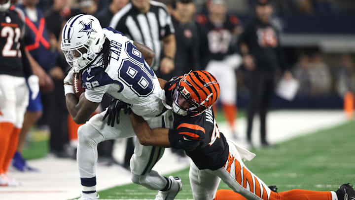 Dec 9, 2024; Arlington, Texas, USA; Dallas Cowboys wide receiver CeeDee Lamb (88) is tackled by Cincinnati Bengals cornerback Marco Wilson (42) in the first quarter at AT&T Stadium. Mandatory Credit: Tim Heitman-Imagn Images