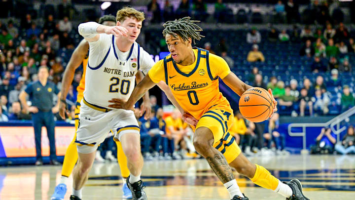 Mar 8, 2025; South Bend, Indiana, USA; Cal Bears guard Jeremiah Wilkinson (0) drives to the basket as Notre Dame Fighting Irish guard J.R. Konieczny (20) defends in the first half at the Purcell Pavilion. Mandatory Credit: Matt Cashore-Imagn Images